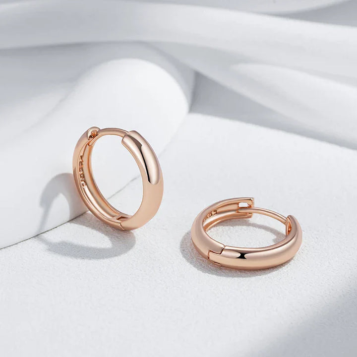 Elegante øreringer i skinnende rosagull